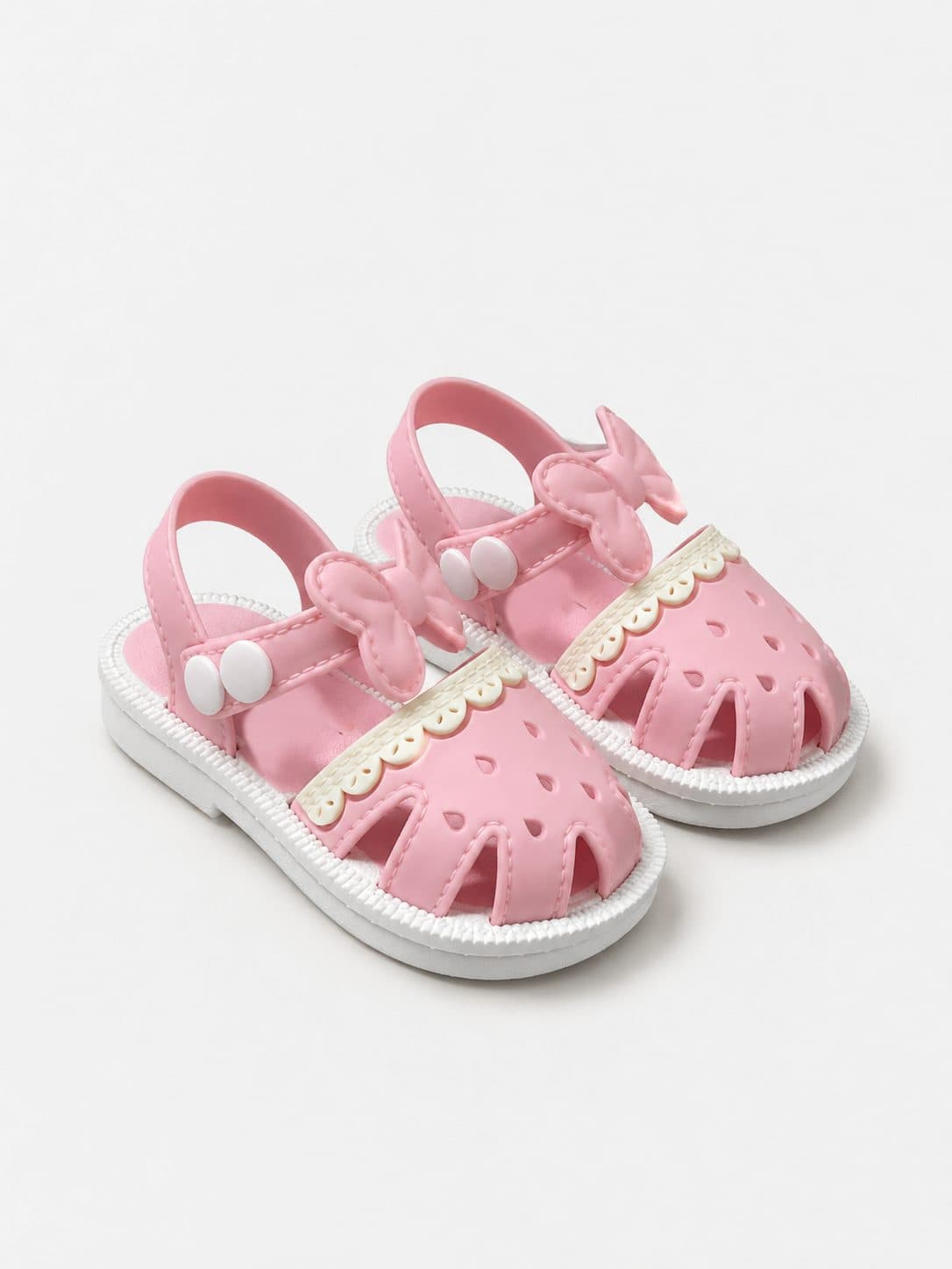 SANDALIA JELLY ROSADA CON LAZO Y RIBETE CALADO — zapatos para niña