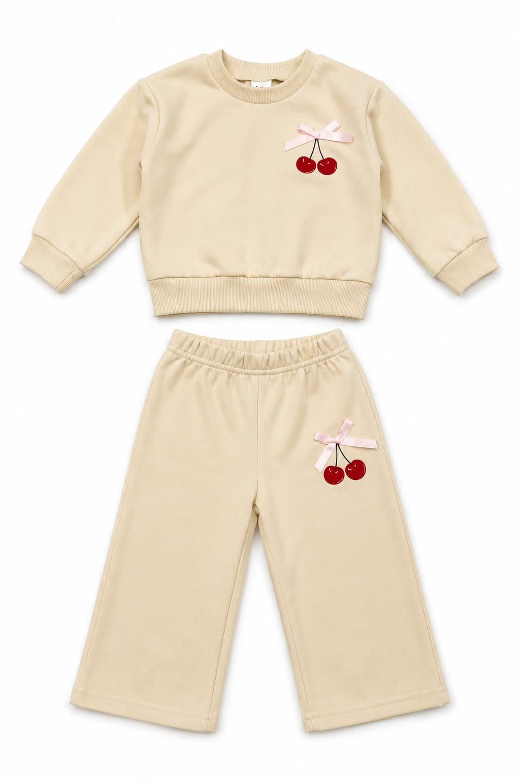 CONJUNTO BUZO Y PANTALÓN BEIGE CON CEREZAS Y MOÑO — conjunto para niña