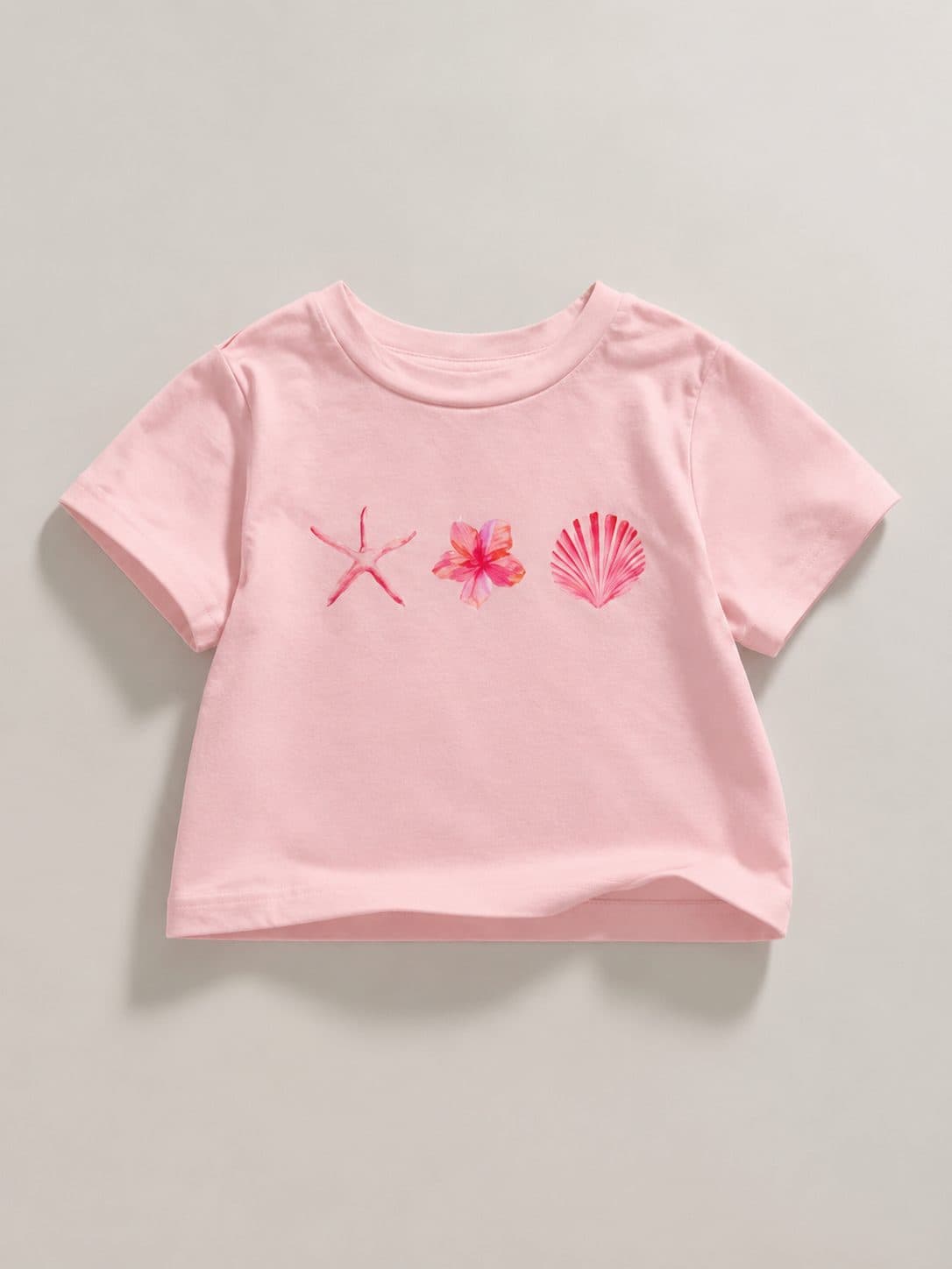 POLO ROSA CON ESTRELLA DE MAR Y CONCHA — polo para niña